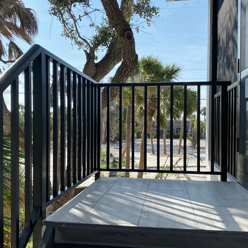 Aluminum railing outside a beautiful home on a sunny day.